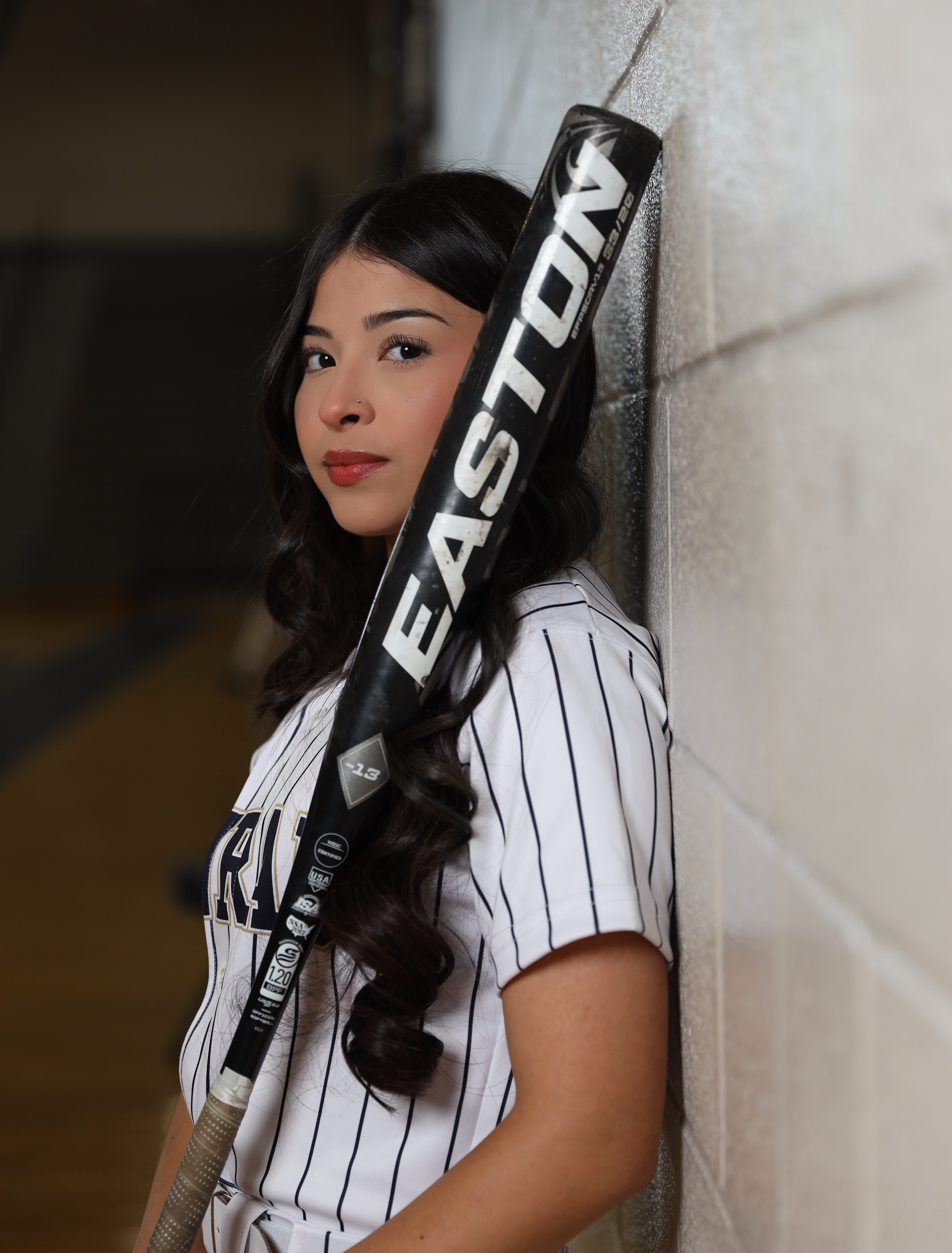 Softball player portrait with dramatic lighting